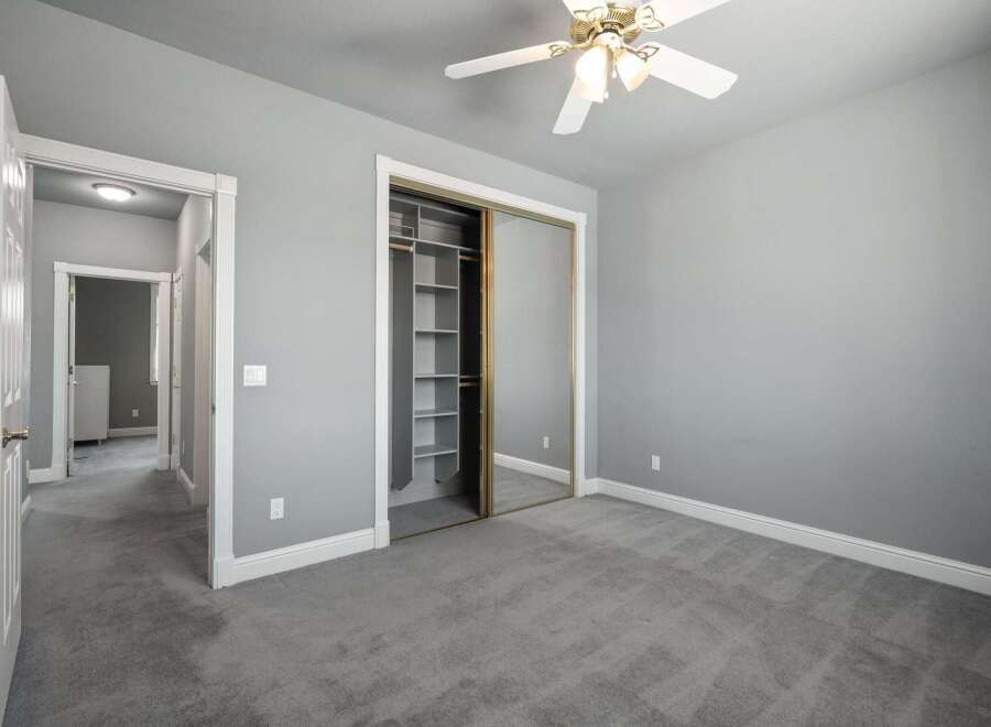 Step into this inviting bedroom featuring a spacious closet with mirrored sliding doors, perfect for organizing your belongings.