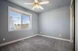This spacious bedroom features a large window offering scenic views of the surrounding landscape.