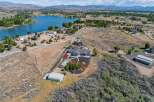 Discover this stunning property featuring a spacious home with a modern design, complemented by a large greenhouse and a convenient Quonset hut for storage.