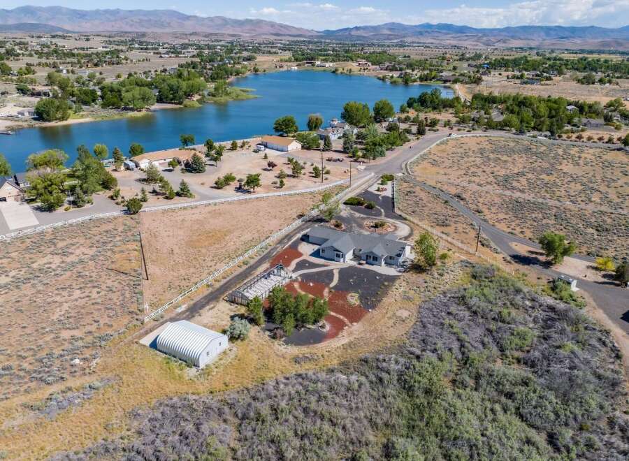 Discover this stunning property offering a serene lakefront lifestyle with a spacious home and ample land.