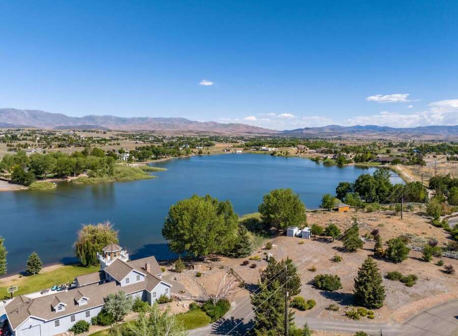 Experience lakeside living at its finest with this stunning property offering panoramic views of the serene blue water.