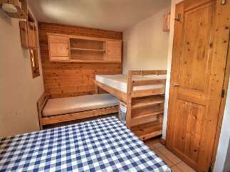 This charming room features a cozy bunk bed setup, perfect for families or groups.
