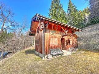 Discover this charming rustic wooden cabin nestled in a serene mountain landscape.