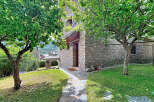 Discover this charming stone house nestled amidst lush greenery and mature trees, offering a serene retreat.