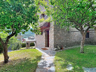 Discover this charming stone house nestled amidst lush greenery and mature trees, offering a serene retreat.