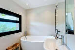 This modern bathroom features a freestanding bathtub and a sleek sink, perfect for a spa-like experience at home.