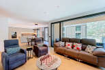 Experience modern living in this spacious open-plan apartment, featuring a sleek, integrated kitchen with state-of-the-art appliances and a dining area perfect for entertaining.