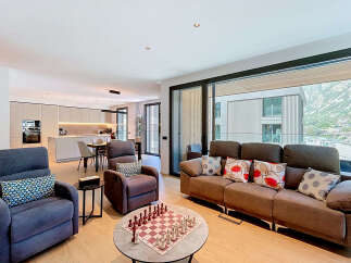 Experience modern living in this spacious open-plan apartment, featuring a sleek, integrated kitchen with state-of-the-art appliances and a dining area perfect for entertaining.