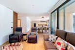 Experience modern living in this spacious open-plan apartment, featuring a sleek, integrated kitchen and a comfortable living area perfect for relaxation and entertainment.