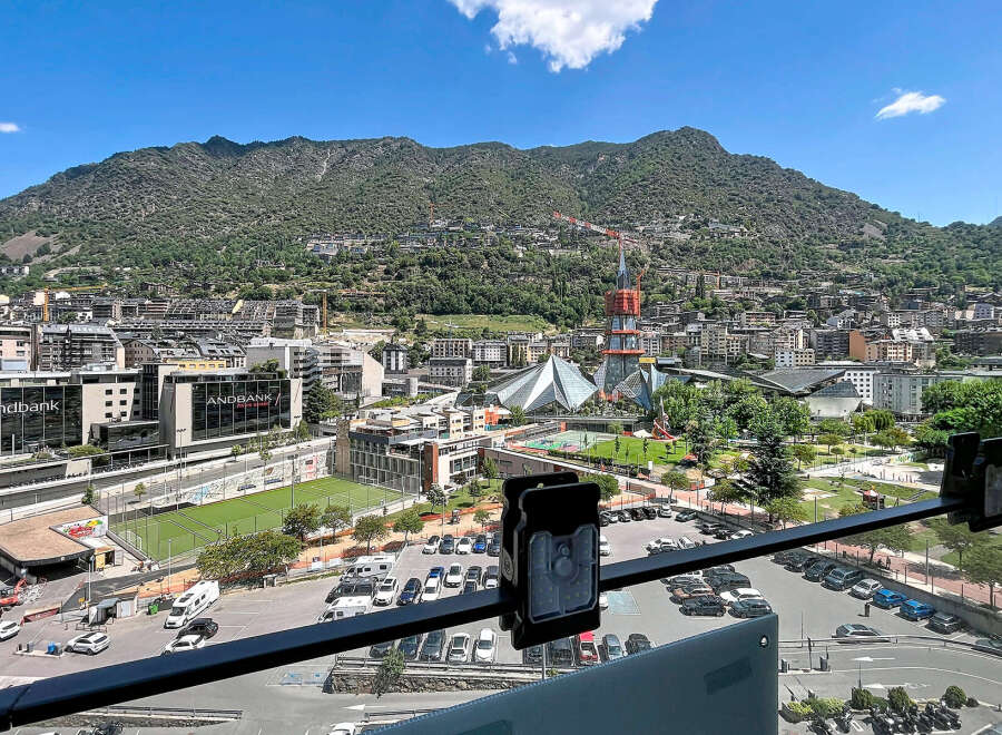 Experience urban living with a mountain backdrop in this vibrant city view.