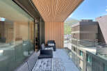 Experience luxurious outdoor living on this spacious balcony, featuring comfortable seating and a stylish tiled accent.