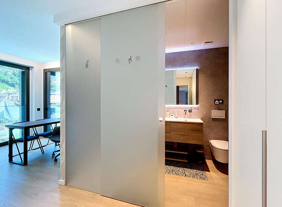 Discover modern living with this stunning apartment featuring a spacious dining and workspace area with large windows offering scenic views.