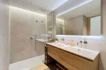 Experience modern luxury in this stunning bathroom featuring a spacious walk-in shower with a rainfall showerhead and a sleek double vanity with ample counter space.