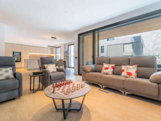 Experience modern living in this spacious open-concept home, featuring a sleek kitchen and a comfortable living area perfect for relaxation and entertainment.