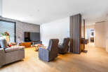 This modern living room features a comfortable grey sofa and two recliners, perfect for relaxation.