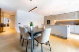 Experience modern living in this stunning open-concept space, featuring a sleek dining area with a contemporary table and chairs, perfect for intimate gatherings.