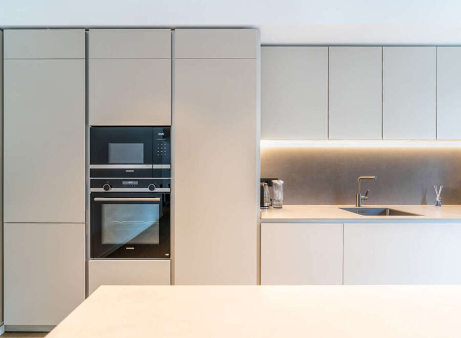 Experience modern luxury in this sleek kitchen, featuring integrated Siemens appliances including a microwave and oven.