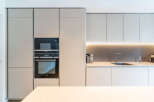 Experience modern luxury in this sleek kitchen, featuring integrated Siemens appliances including a microwave and oven.