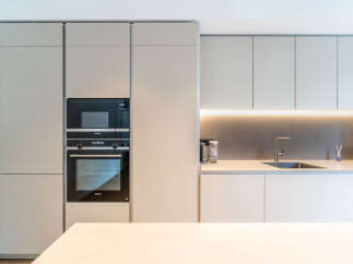 Experience modern luxury in this sleek kitchen, featuring integrated Siemens appliances including a microwave and oven.