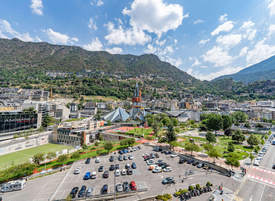 Discover this vibrant urban landscape nestled against a majestic mountain backdrop.