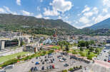 Discover this vibrant urban landscape nestled against a majestic mountain backdrop.