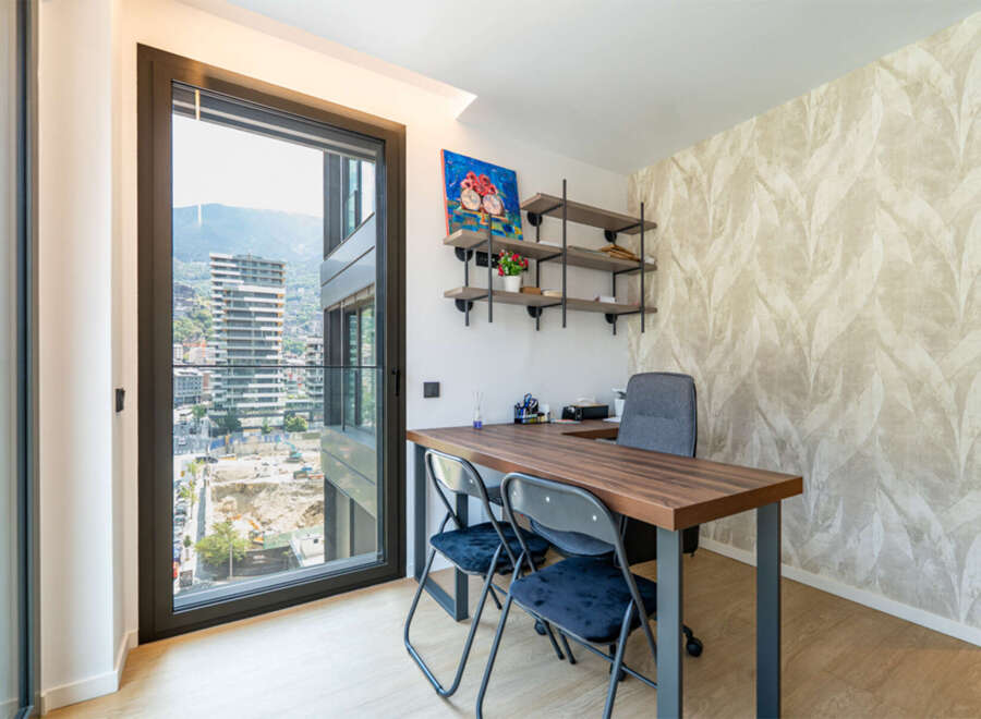 This modern office space features a large desk with two chairs, perfect for collaboration or individual work.