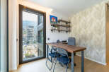 This modern office space features a large desk with two chairs, perfect for collaboration or individual work.