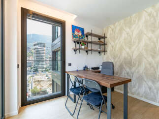 This modern office space features a large desk with two chairs, perfect for collaboration or individual work.