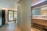 Experience modern living in this stylish apartment featuring a spacious living area with a large window offering scenic views.