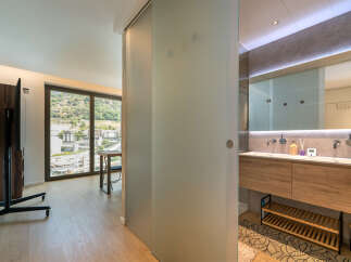 Experience modern living in this stylish apartment featuring a spacious living area with a large window offering scenic views.