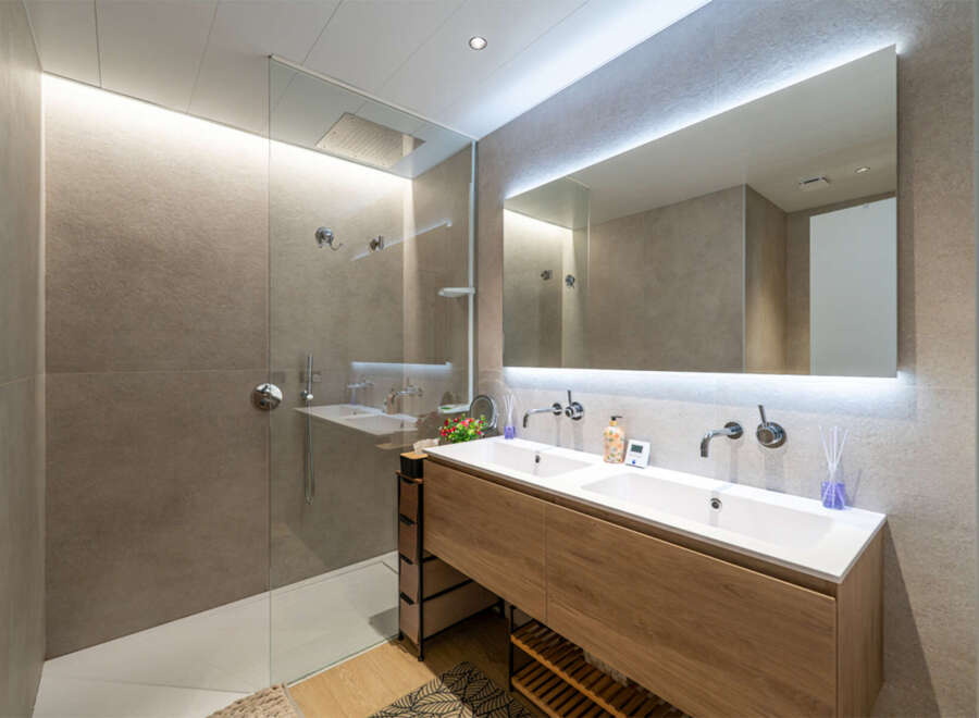 Experience modern luxury in this stunning bathroom featuring a spacious walk-in shower with a rainfall showerhead and sleek glass enclosure.