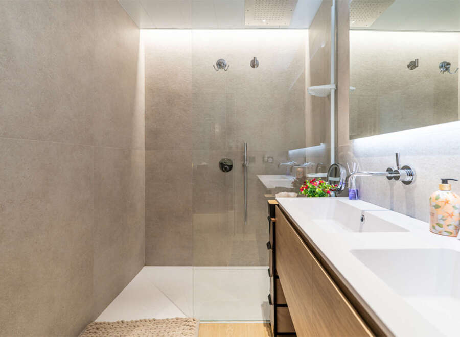 Experience modern luxury in this stunning bathroom featuring a spacious walk-in shower with sleek fixtures and a double vanity with ample counter space.