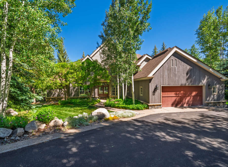 Nestled amidst lush greenery and mature trees, this stunning mountain home offers a serene retreat.