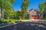 Nestled amidst lush greenery and mature trees, this stunning mountain home offers a serene retreat.