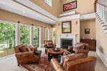 Step into this inviting living room featuring plush leather armchairs arranged around a central coffee table, perfect for intimate gatherings.