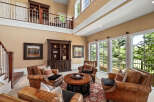 Experience luxurious living in this grand living room, featuring plush leather armchairs arranged around a central coffee table, perfect for intimate gatherings.