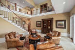 Step into this grand living space featuring a stunning two-story staircase and a loft overlooking the main floor.