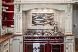 Experience culinary excellence in this stunning kitchen, featuring a professional-grade range with dual ovens and a gas cooktop.