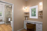 Experience luxury and convenience in this stunning bathroom featuring a spacious walk-in shower with elegant tile work and a freestanding bathtub.