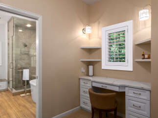 Experience luxury and convenience in this stunning bathroom featuring a spacious walk-in shower with elegant tile work and a freestanding bathtub.