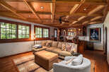 Step into this inviting living space featuring a plush sectional sofa and a cozy armchair, perfect for relaxation.