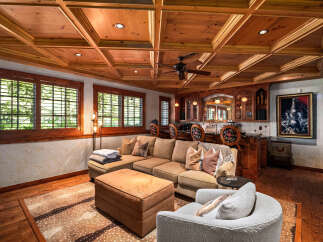 Step into this inviting living space featuring a plush sectional sofa and a cozy armchair, perfect for relaxation.