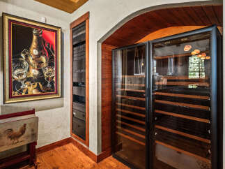 Experience the ultimate in wine preservation with this state-of-the-art wine cellar, featuring dual-zone temperature control and ample shelving.