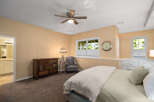 This charming bedroom features a comfortable bed with plush bedding, complemented by a stylish dresser and a cozy armchair.