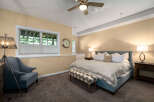 Discover comfort and style in this inviting bedroom, featuring a plush king-size bed adorned with crisp white linens and accent pillows.