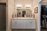 This spacious bathroom features a double vanity with ample storage and elegant fixtures, perfect for a busy household.