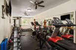 Elevate your fitness routine in this fully equipped home gym, featuring state-of-the-art treadmills, stationary bikes, and a rowing machine.