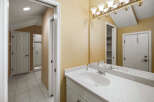 This bathroom features a spacious vanity with a speckled countertop and a modern undermount sink, complemented by a polished chrome faucet.