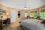 This charming bedroom features a cozy ambiance with its warm, neutral-toned walls and plush carpeting.