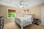 This charming bedroom features a comfortable queen-size bed with a decorative metal frame, complemented by a white duvet and patterned pillows.